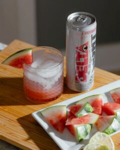delta water can on table with watermelon slices around it